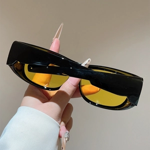 Close-up of black rectangle sports sunglasses with amber yellow translucent lenses