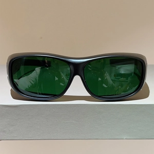 Front view of large frame sports safety glasses with green lenses and black wrap-around frame