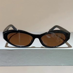 Vintage cat eye sunglasses with thick black frame and translucent brown lenses