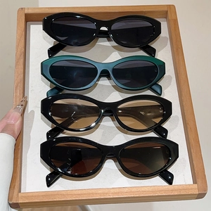 Vintage cat-eye sunglasses collection in various colors displayed on a tray