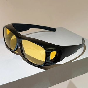 Detail view of black frame sport sunglasses with yellow lenses and side shield windows