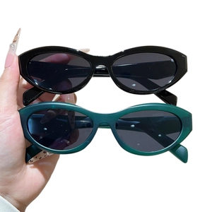 Vintage cat-eye sunglasses with oval frames in glossy black and dark green colors