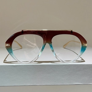 Front detail of oversized tricolor gradient glasses with a gold metal top bar accent