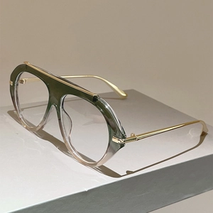 Detail of pilot glasses frame with green gradient finish and gold metal temples