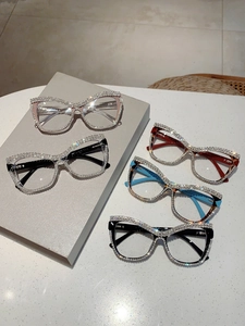Macro view of crystal encrusted cat eye frame glasses with sparkling diamond details