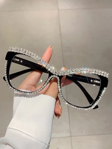 Detailed view of luxury cat-eye glasses with sparkling rhinestones and black frame