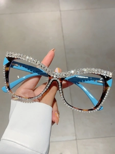 Close-up of tortoise frame glasses with hand-set rhinestones and blue temples