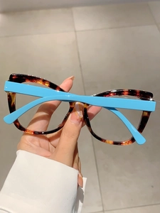 Detail of tortoise frame glasses with sky blue temples and rhinestone top accents