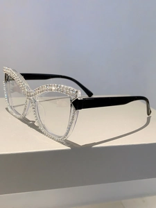 Close-up of cat-eye glasses frame with sparkling rhinestones and transparent temples