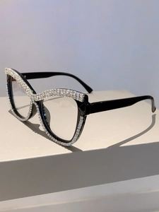 Detail view of cat eye glasses frames with dense white rhinestone inlays and black temples