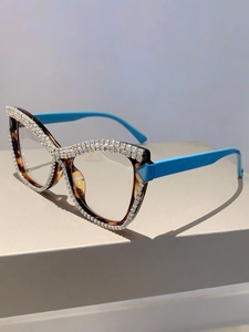 Cat eye glasses featuring tortoiseshell frame with rhinestones and bright blue temples