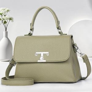 Green lychee grain leather tote bag with silver TG logo and adjustable shoulder strap