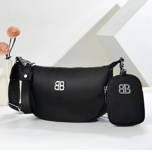 Black nylon crescent crossbody bag with wide logo strap and detachable coin purse