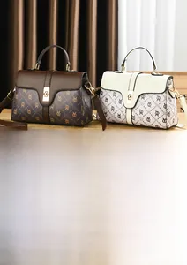 Detail of vintage patterned handbags with gold hardware and removable shoulder straps