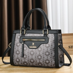 Sac à main noir avec motif géométrique vintage et détails de fermeture éclair dorée