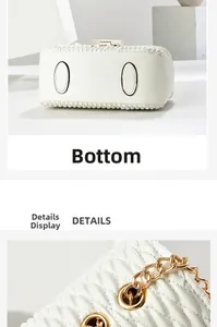 Detailed view of white quilted handbag base with protective studs and gold chain