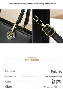 Detail of gold metal buckles on a black minimalist handbag with textile leather texture