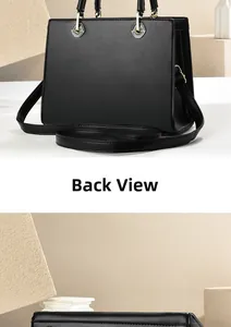 Detail view of the back of a large black leather tote bag with silver hardware accents