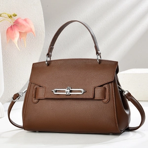 Elegant brown pebble leather bucket bag with top handle and silver metal lock closure