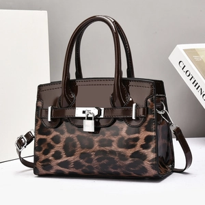 Close-up of leopard print and glossy patent leather luxury handbag with gold metal lock