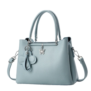 Elegant light blue litchi pattern leather tote bag with butterfly pendant and crossbody strap