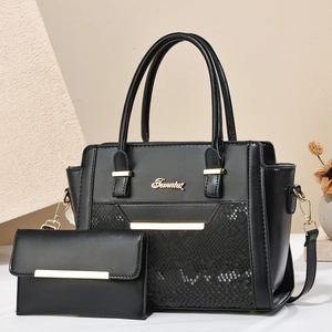 Elegant black leather handbag set with snake-pattern texture and gold metal hardware