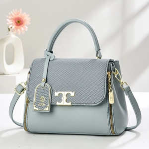 Light blue pebbled leather handbag for women with gold T-logo buckle and top handle