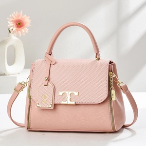 Elegant pink textured leather tote bag with gold T-shaped clasp and floral decor
