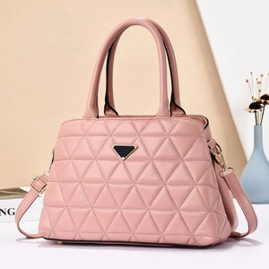 Macro shot of pink quilted faux leather handbag with triangle logo and adjustable strap