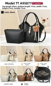 Detail view of leather handbag set with inner pouch and cute teddy bear keychain