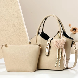 Elegant beige pebbled leather bucket tote bag set with a cute plush bear pendant