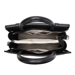 Top view of black tote bag interior with multiple compartments and golden hardware