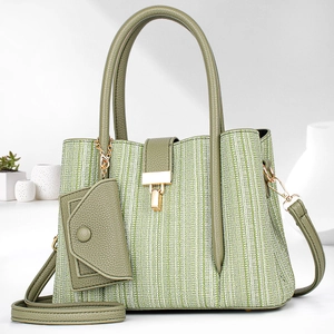Matcha green woven handbag with leather trim and small pouch on minimalist background