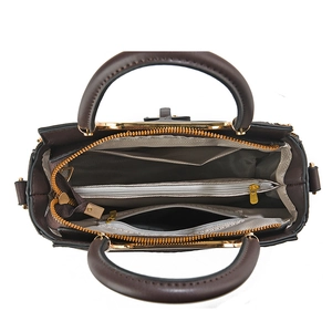 Interior detail of large crossbody bag featuring multiple compartments and gold hardware