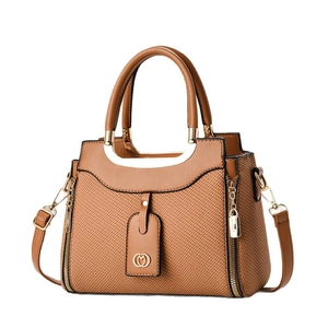 Caramel brown leather and woven fabric crossbody bag with gold zippers and handles