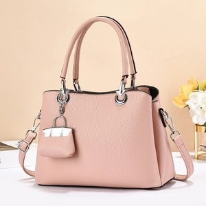 Pink lychee grain leather handbag with matching mini bag charm and silver hardware
