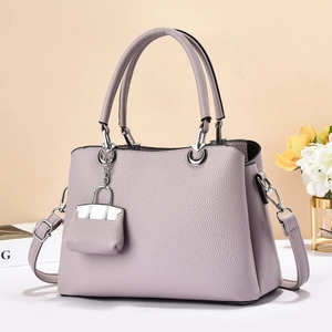 Minimalist lavender lychee grain tote bag with top handles and a mini charm accessory