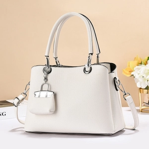 Minimalist white litchi pattern handbag with detachable strap and mini bag charm