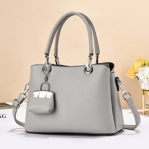 Gray lychee grain leather tote bag with silver hardware and mini charm accessory
