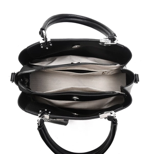 Interior view of black pebbled leather bag with multiple compartments and silver hardware