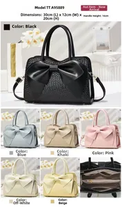 Detail view of crocodile pattern bag with bow design showing 30x12x20cm dimensions