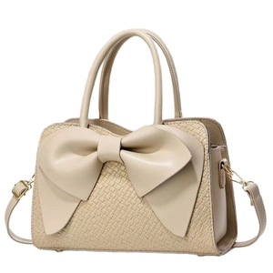 Beige faux leather handbag with embossed texture and a large decorative front bow