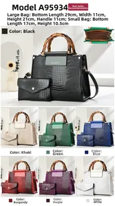 Detail view of crocodile pattern faux leather handbag set with bamboo handles and multi-colors