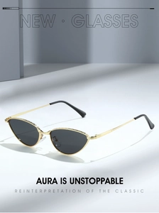Macro view of gold metal cat-eye sunglasses featuring detailed rhinestone embellishments