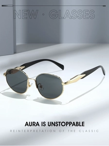 Close-up of golden metal frame detail and sleek black temples on retro round sunglasses