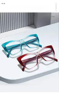 Detail of cat eye glasses frames in gradient blue and burgundy on a modern display stand