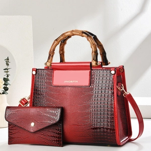 Red crocodile embossed handbag set with bamboo handles and matching small envelope clutch