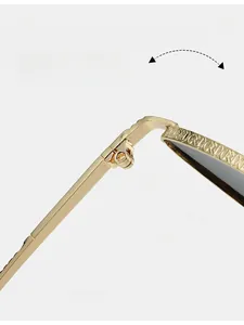 Macro detail of golden metal frame with durable hinge and textured temple pattern