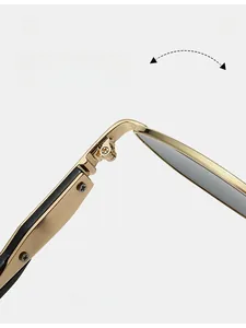 Detail of durable golden metal hinge and screws on vintage small frame sunglasses