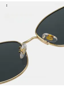 Macro view of adjustable silicone nose pads on gold metal frame retro sunglasses